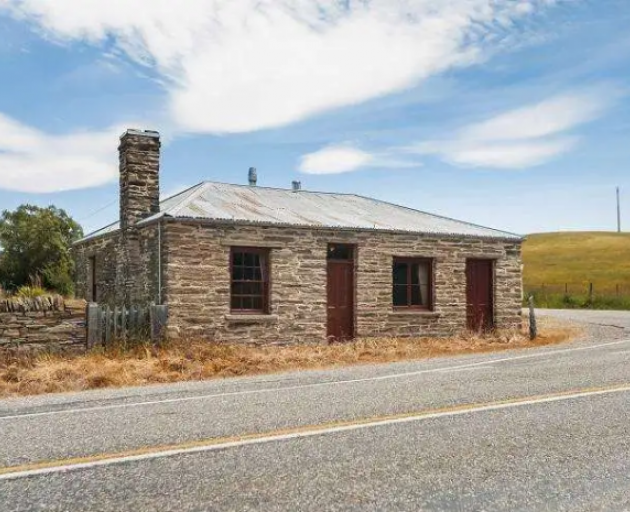 The restored 1897 stone cottage near St Bathans, sits in the Maniototo county of Central Otago,...