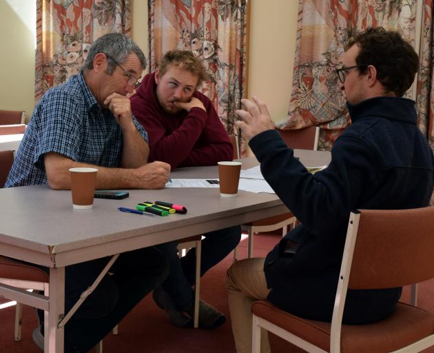Sheep and beef farmers Gordon Thomson (left) and his son Corey Thomson work on their intensive...