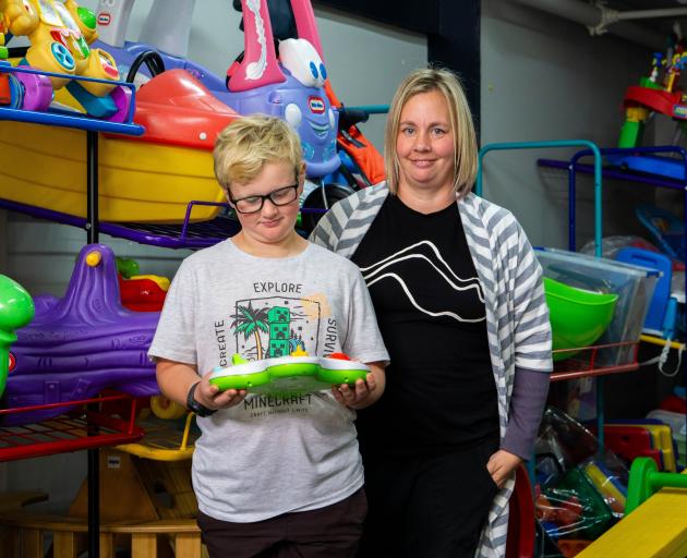 Alex Henderson, 8, checks out one of the toys alongside North Otago Toy Library president Sarah...