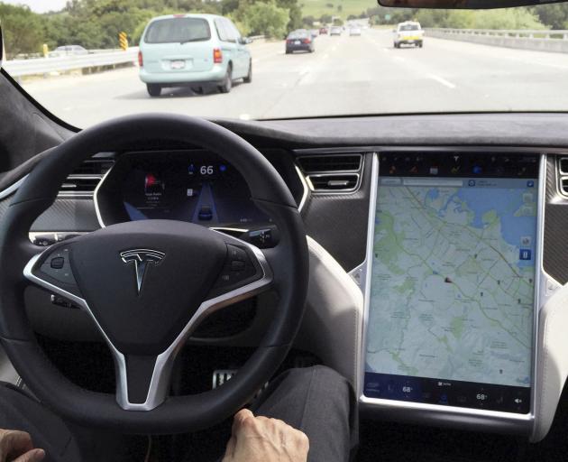 Tesla's Autopilot is intended to enable cars to steer, accelerate and brake automatically within...