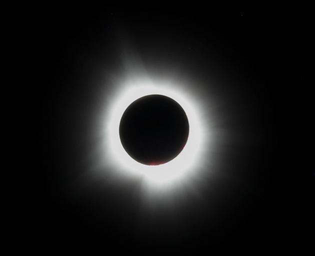 The moon blots out the sun, during a total solar eclipse, as seen from Carbondale in the US state...
