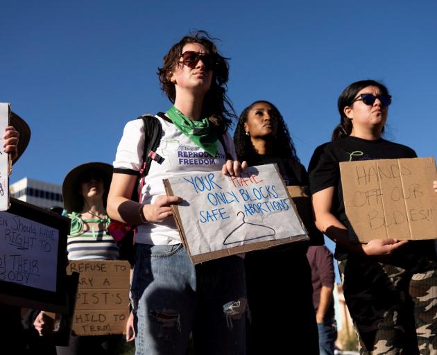 Protesters take part in a rally led by Women's March Tucson after Arizona's Supreme Court revived...