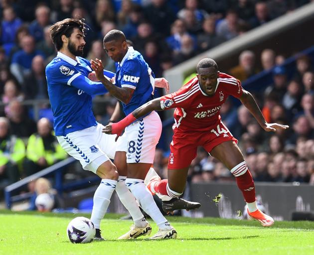 Everton's Andre Gomes and Ashley Young in action with Nottingham Forest's Callum Hudson-Odoi....
