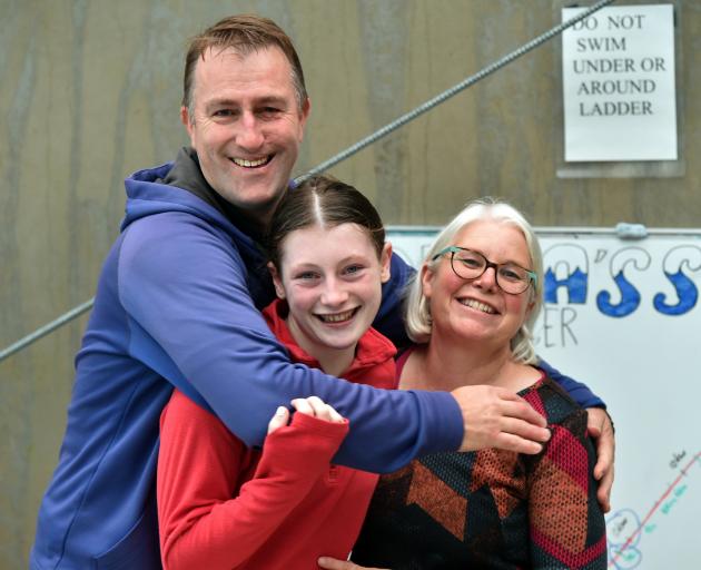 Swimmer Anna Harrex is hugged by her parents Andrew and Christine. PHOTOS: GREGOR RICHARDSON