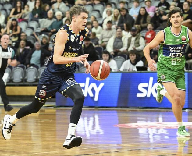 Otago Nuggets guard Ben Henshall takes the ball up court while chased by Manawatu Jets forward...
