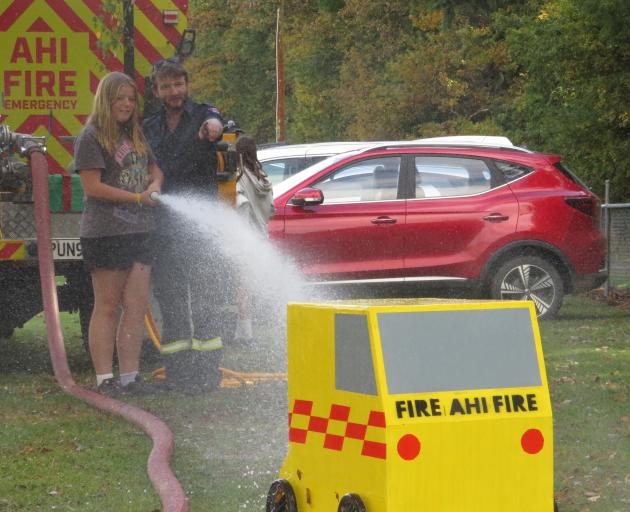 Hazel Lock, 12, of Methven tests out the water pressure of the Lauriston Fire Brigade's hose with...