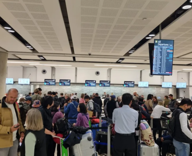People queue to rebook flights at Christchurch Airport on 20 April 2024. Photo: RNZ