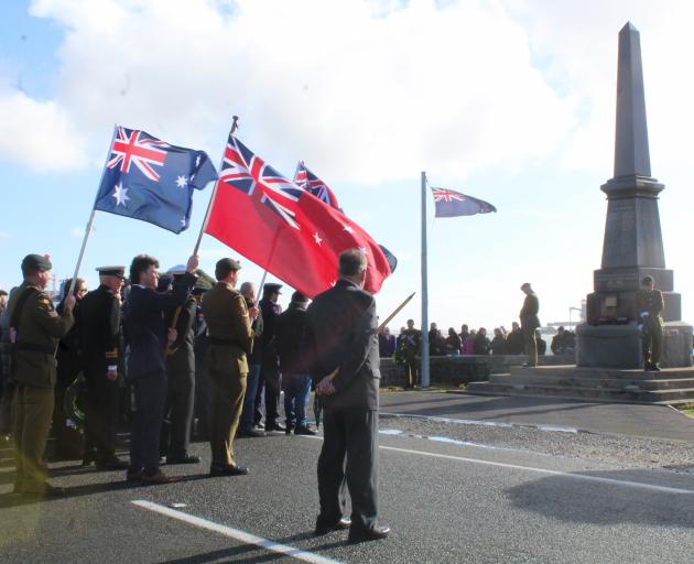 Flags flutter  during the Anzac Day civic ceremony at the Bluff Cenotaph. PHOTO: NINA TAPU