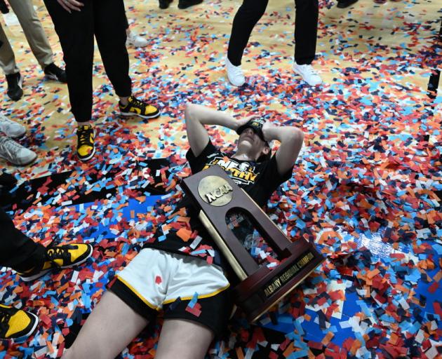 Rising basketball star Caitlin Clark celebrates after leading her side to victory over LSU to...