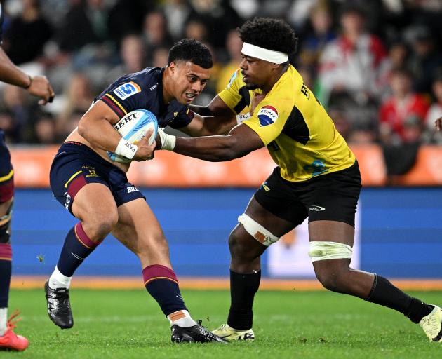 Ajay Faleafaga of the Highlanders runs into Hurricanes defence during their recent clash in...