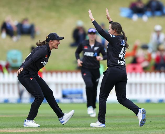 Black Caps Amelia Kerr celebrates with Suzie Bates after taking the wicket of England's Danni...