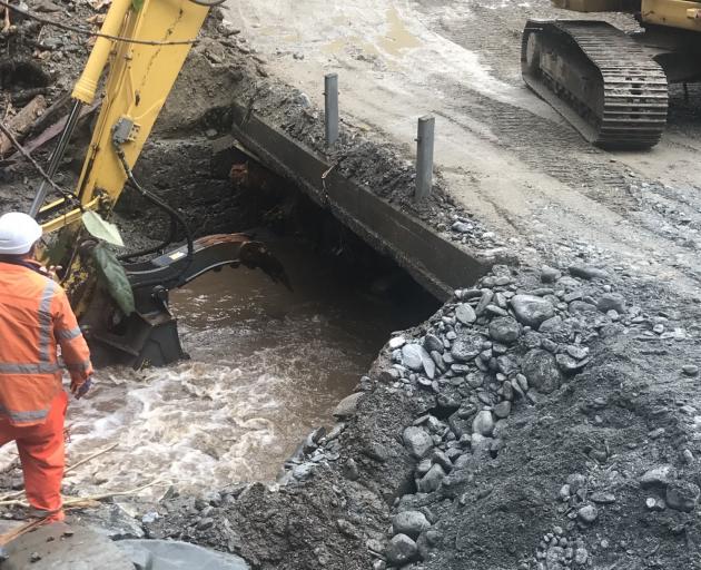 Road crews working on the temporary fix to SH6 at Smithy's Creek this morning. Photo: NZTA