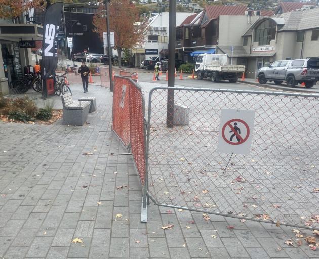 The narrow pathway left for people to get to Alta, in Queenstown, as a result of a roadworks...