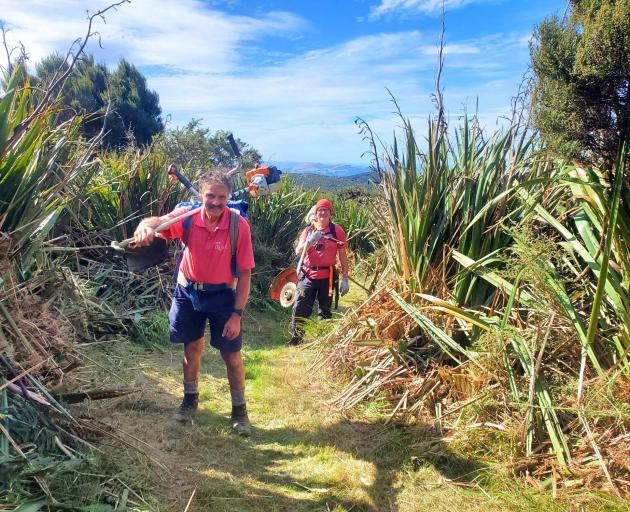 Dave McLean (left) and Rex Thompson walk up Swampy Ridge Track during a recent track clearing day...