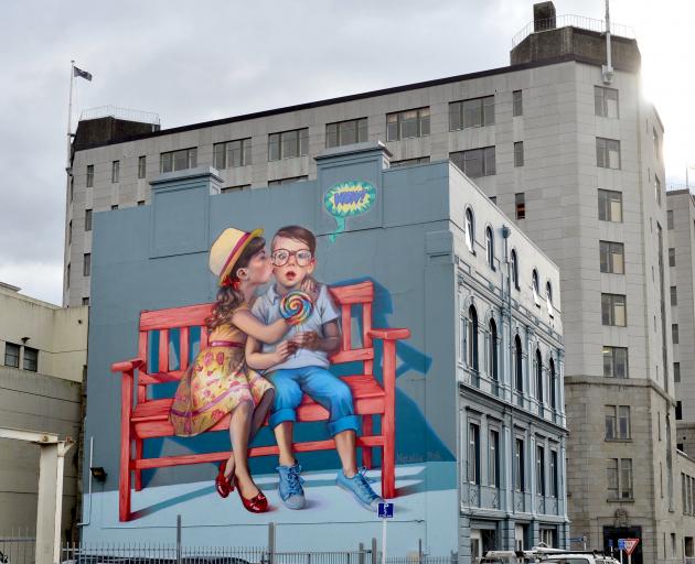 'Love is in the Air' was painted on the  side of   Mansfield Apartments in 2015 by Polish artist...