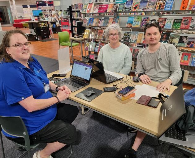 TechMate volunteers help resident with her laptop at Linwood library. PHOTO: SUPPLIED