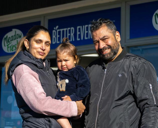 Thames Discounter and Takeaways owners Tania and Sunny Bal with daughter Grace, 2, outside the...
