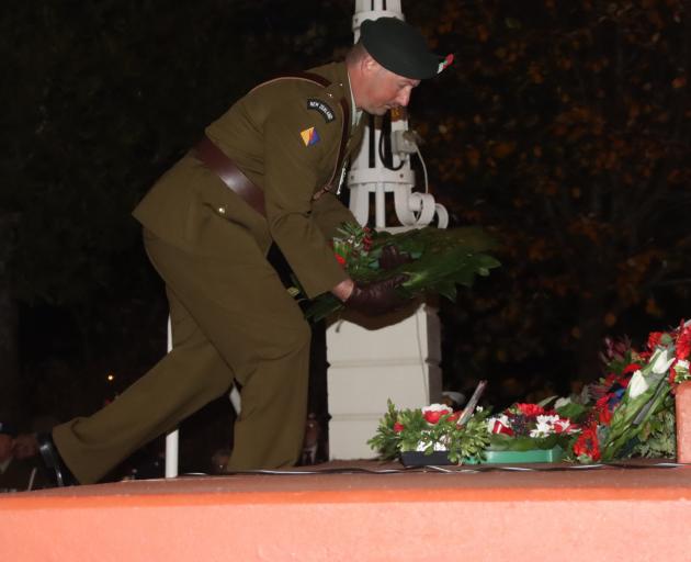 Royal New Zealand Infantry 2/4 Regiment 2nd lieutenant Paul McCullough lays a wreath during the...
