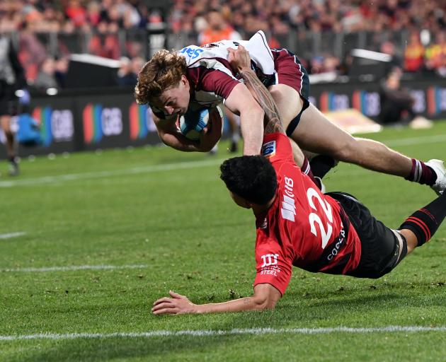 Tim Ryan of the Reds dives over to score a try. Photo: Getty Images