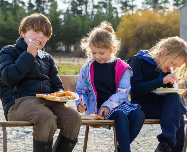Enjoying some kai at the recent Omarama Station hāngi are (from left) Arlo Leopold, 8, Amelia...