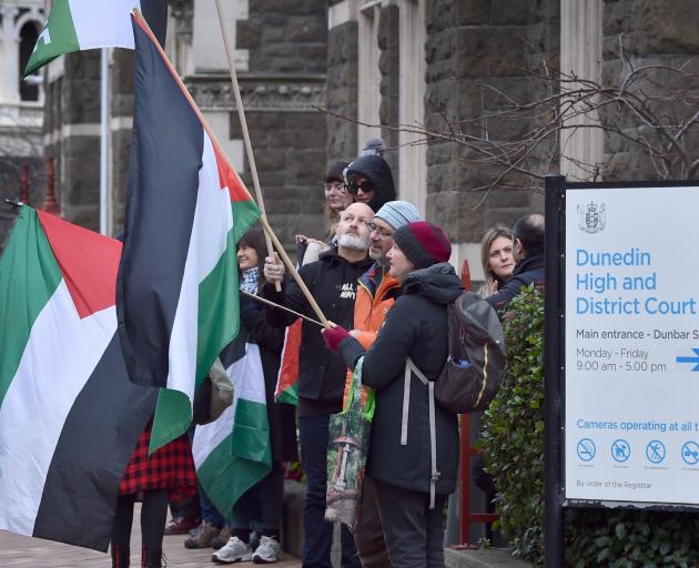 Pro-Palestine demonstrators stand outside the Dunedin District Court in support of a fellow...