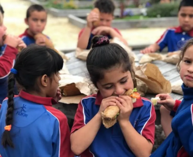 Henry Hill School children tucking into a free school lunch provided through the Ka Ora, Ka Ako...