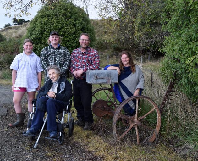 Posing near their letterbox made from a McCormick sickle bar mower to make hay on their family...