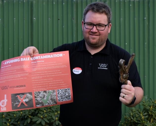 Woolworks New Zealand South Island innovation manager Mitchell Young holds a sign on ways to...