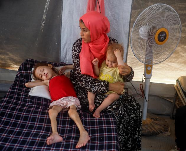 Malnourished children receive treatment at the International Medical Corps field hospital in...