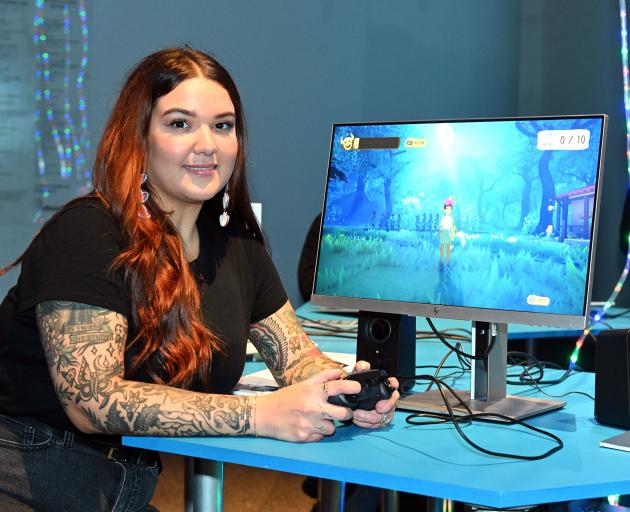 Game developer Elaine Gomez, of Puerto Rico, demonstrates a game she has developed called...