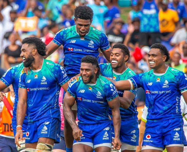 Frank Lomani of the Fijian Drua celebrates with team-mates after a try during the Super Rugby...