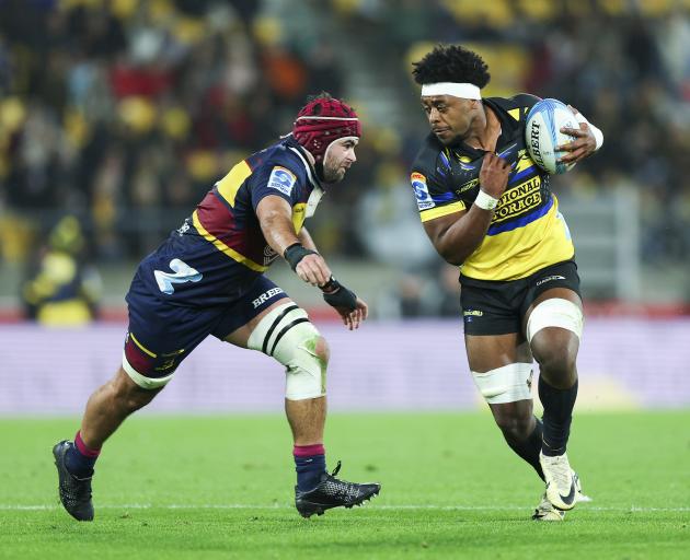 Peter Lakai of the Hurricanes attempts to evade Billy Harmon of the Highlanders. Photo: Getty Images