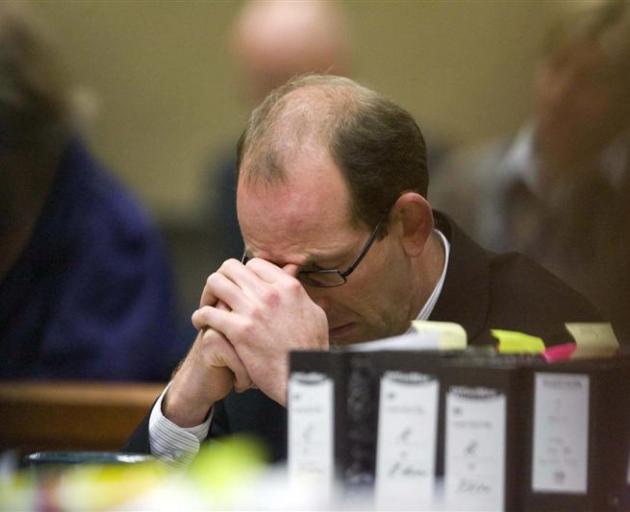 Murder accused David Bain sits with his head down yesterday in the High Court at Christchurch.