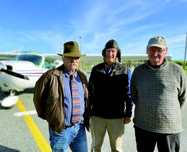 Murray Bowes (left) and Greymouth Aeroclub president Dave McMillan flank pilot Tom Williams on...