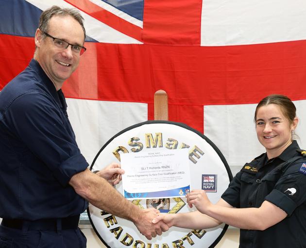 HMS Sultan commanding officer Captain Mark Hamilton congratulates marine engineer officer Sub...