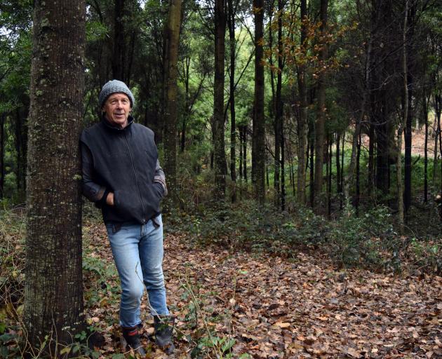 Richard Wilden leans on a blackwood tree on his property in Saddle Hill. Photo: Shawn McAvinue