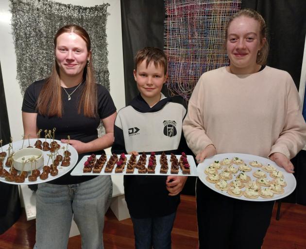 Holding platters of food which they offered to guests at the opening of the Riversdale Arts Mixed...