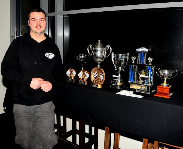 Eleven-time Southland Sports Car Club Champion Liam MacDonald with his trophy haul at this year’s...