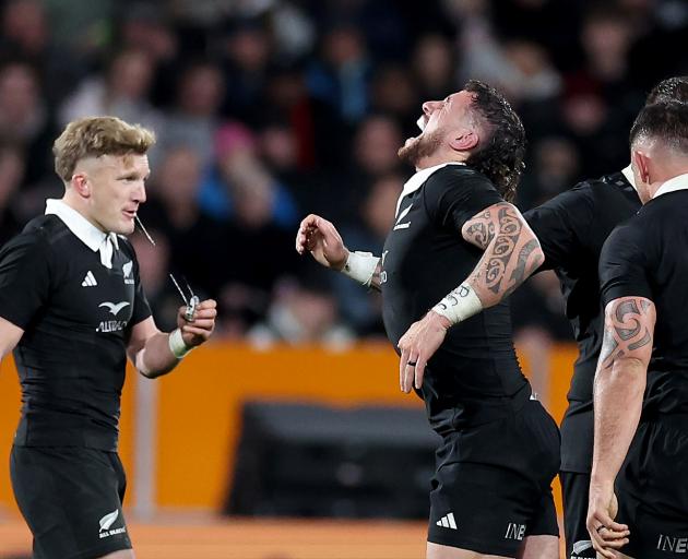 Damian McKenzie and T J Perenara pulling up in pain. PHOTO: GETTY IMAGES