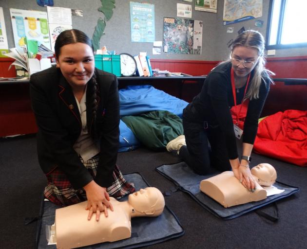 Third-year paramedicine student Kaylee Bezet (right) demonstrates to students, including Waitaki...