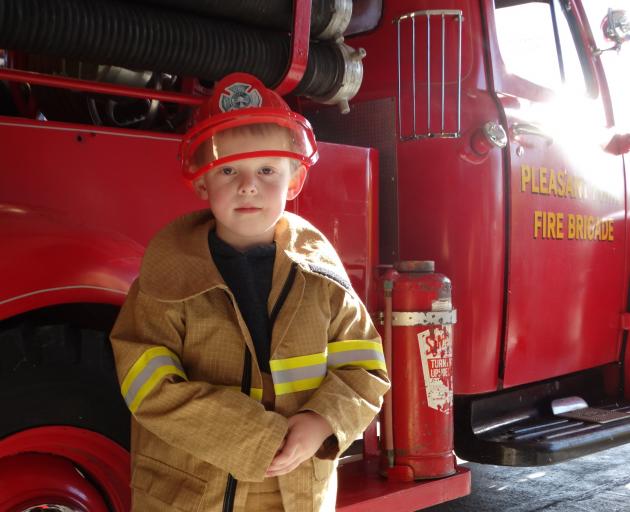 Charles Adams, 5, tries on a firefighter’s uniform. PHOTOS: NIC DUFF