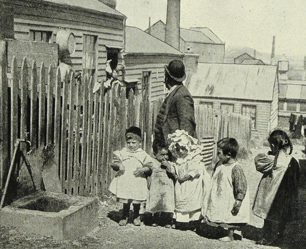 This photograph, taken in February 1904, shows an Assyrian father and his children and is part of...