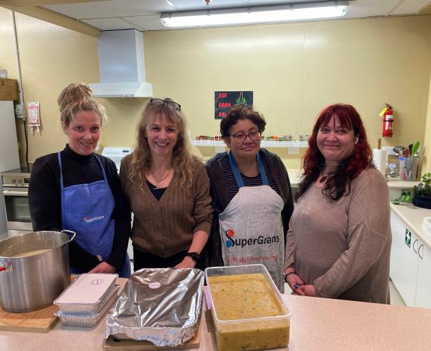 Departing SuperGrans manager Sandy McKay (second from left) gathers with regular Monday cooking...