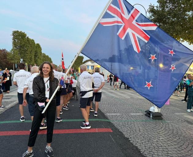Dunedin athlete Anna Grimaldi carries the flag for the New Zealand team at the Paralympics...