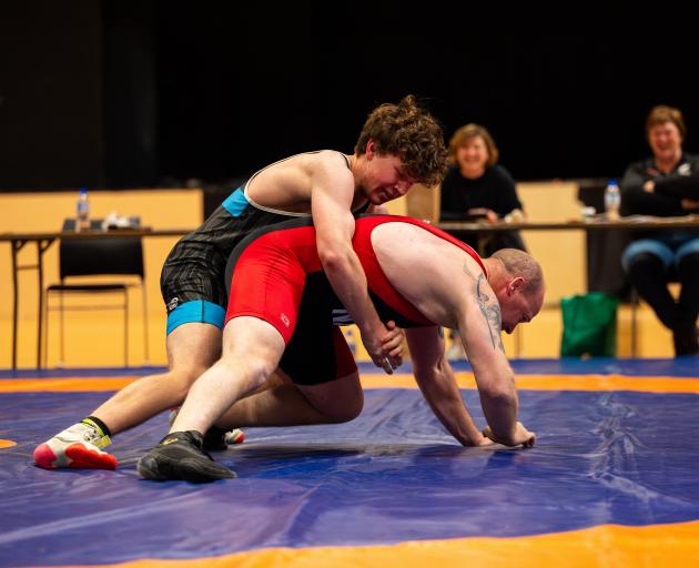 Southern Spartans wrestlers Jaxon Friend (left) and Aron Miller take part in an exhibition bout...