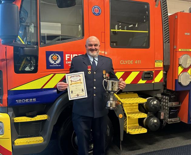 Wyndham Volunteer Fire Brigade member Keith Pirie holds the certificate and trophy he won last...