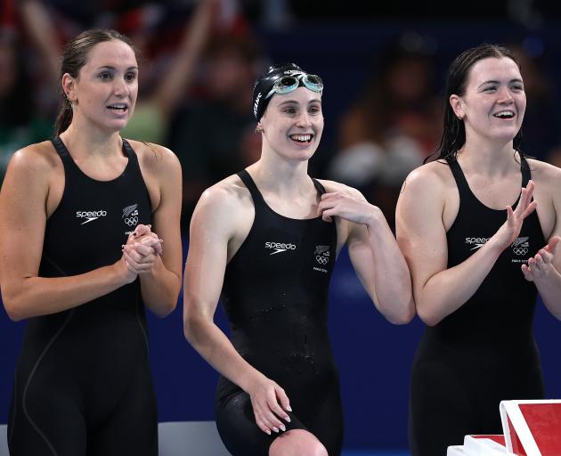 Eve Thomas (left), Caitlin Deans and Erika Fairweather cheer on team-mate Laticia Transom during...