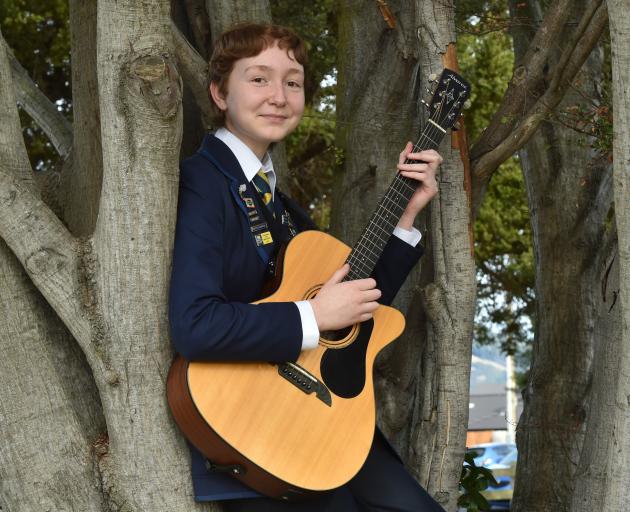 Taieri College student Keira Wallace with their guitar at their school yesterday. PHOTO: GREGOR...
