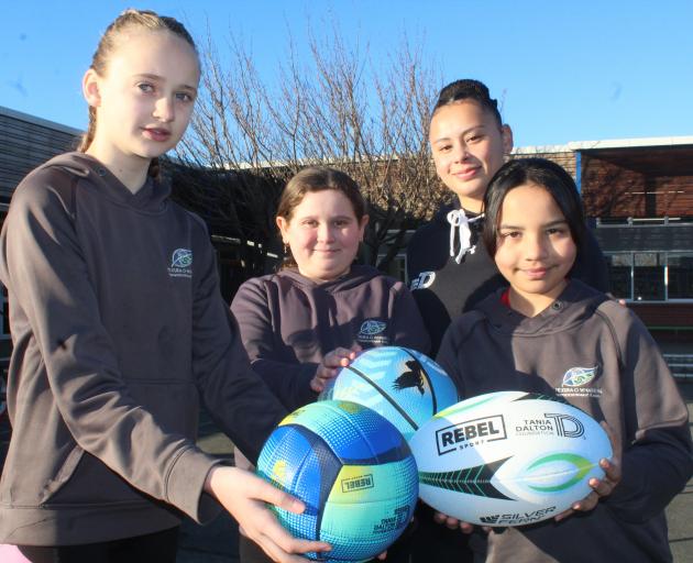 Showing off their new sports balls are Fernworth Primary School pupils (from left) Briah-Rose...