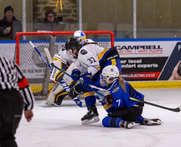 An Auckland Steel player’s pictured holding the stick of a Wild player during overtime in...